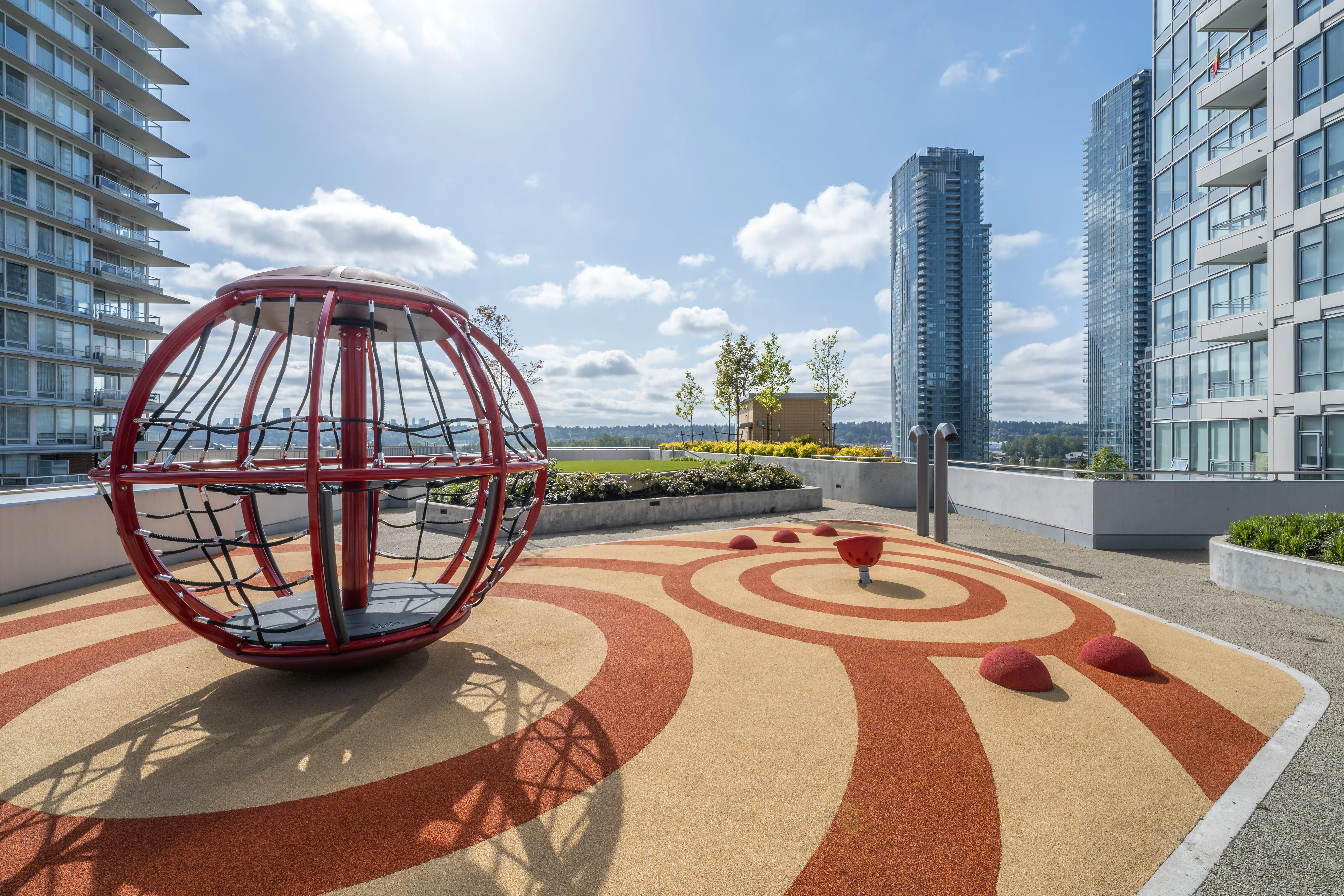 Red sphere climbing structure on a patterned rubber play surface at 618 Carnarvon