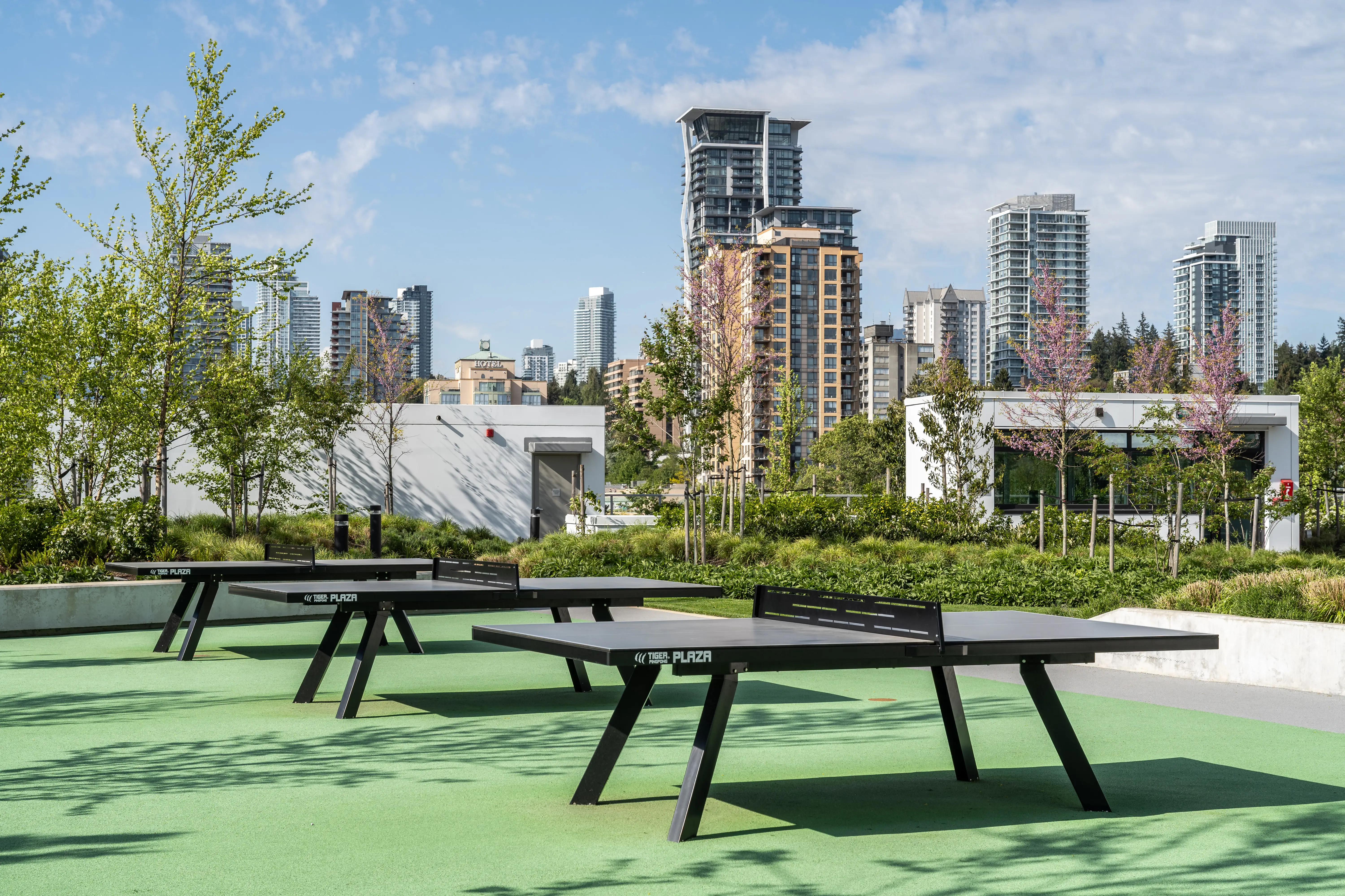 Outdoor table tennis tables on a rooftop with city views at Soco
