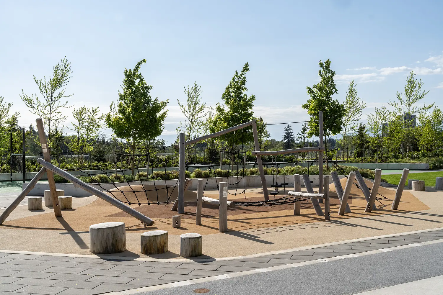 Timber play structure with log stumps in a rooftop playground