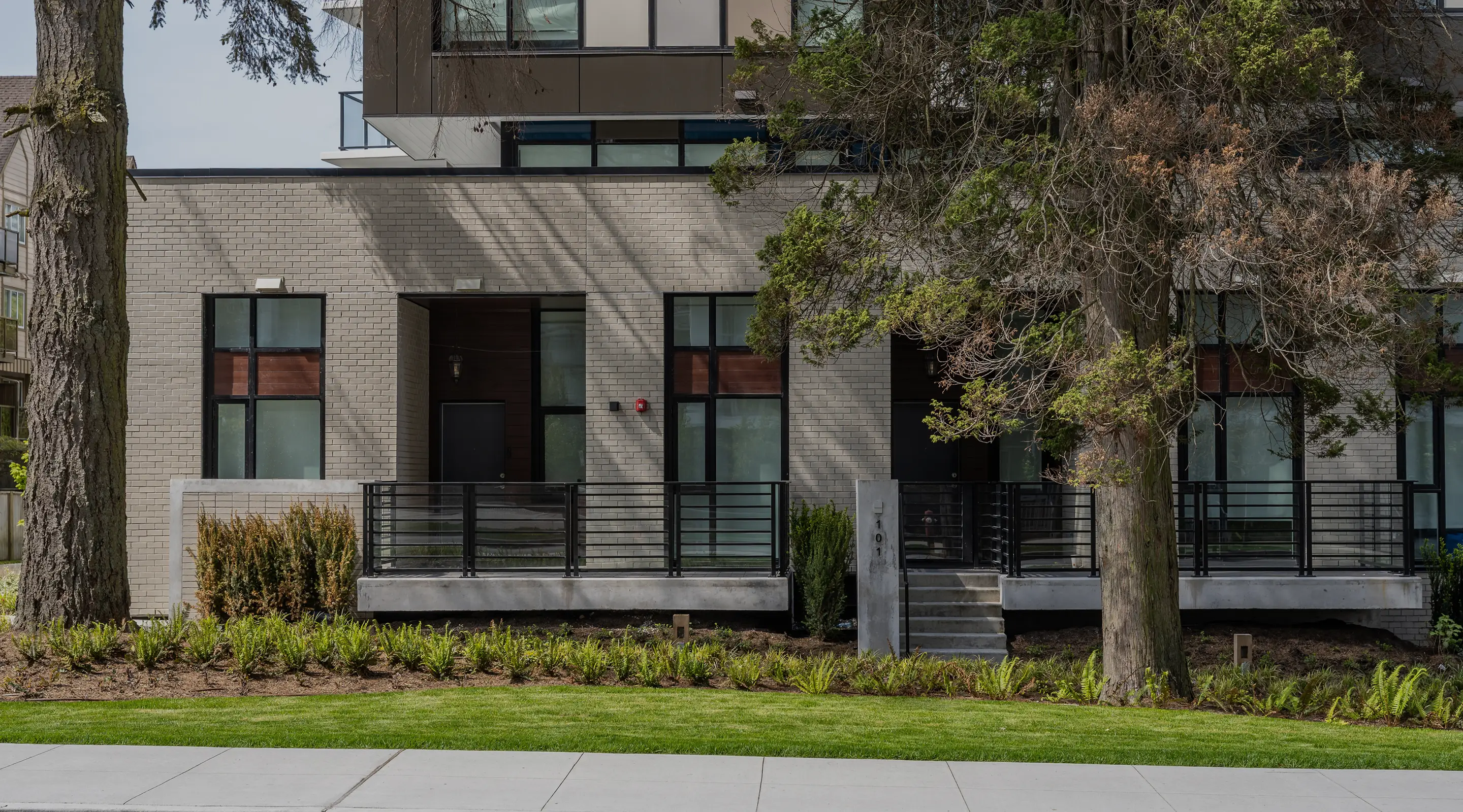 Shrub and tree planting along the front of a townhome building
