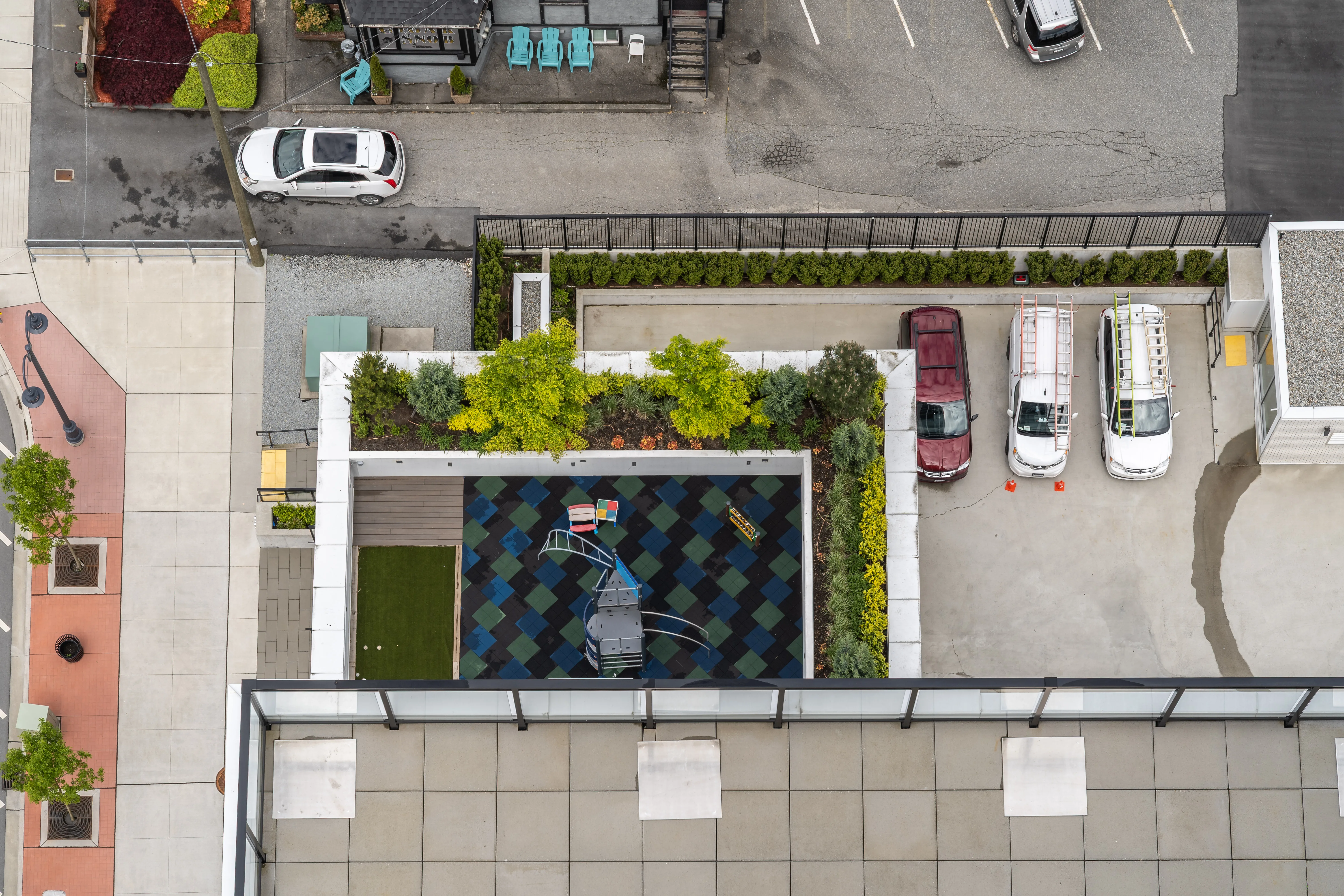 Aerial view of a rooftop amenity area with planting at Loma