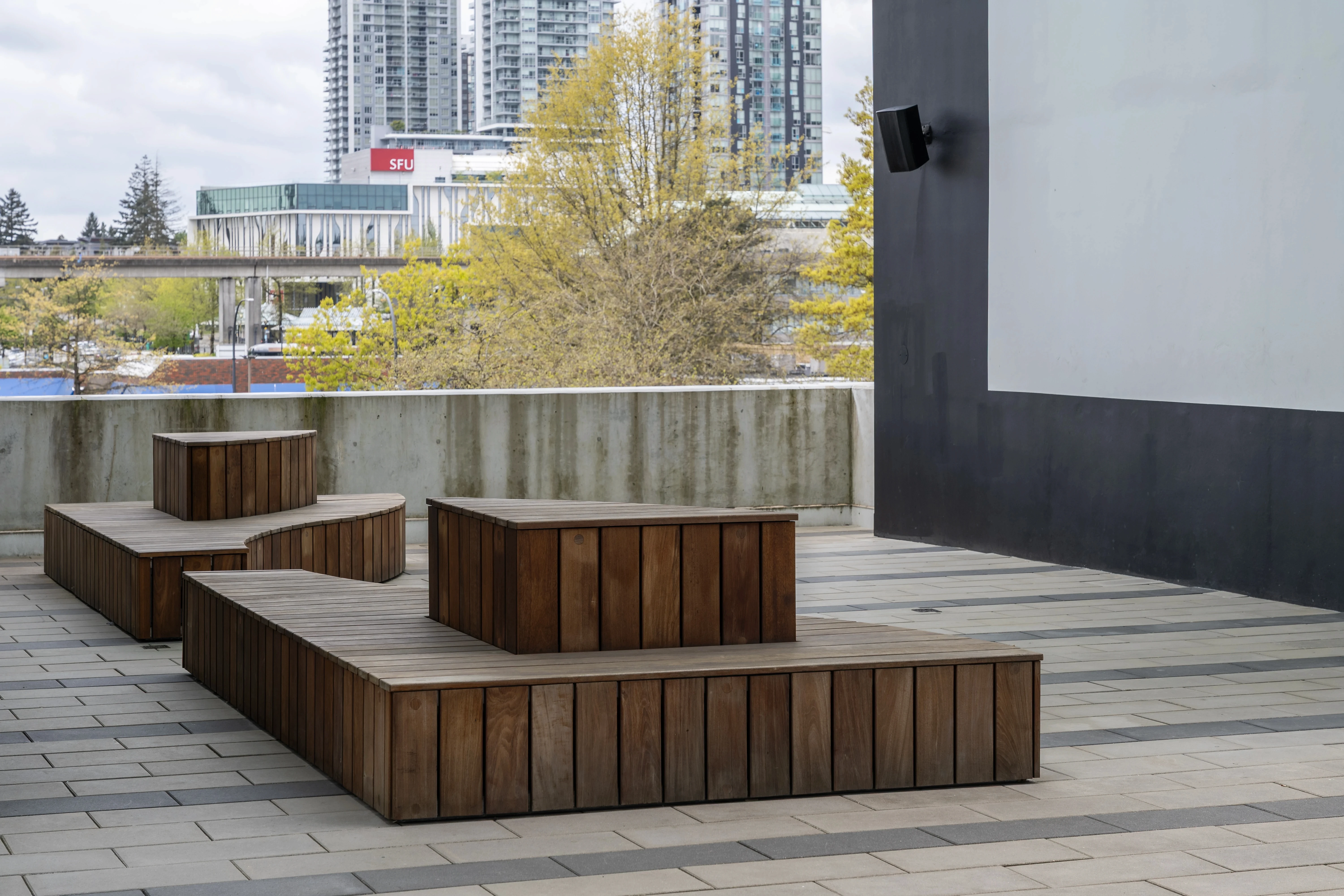 Timber block seating on a paved plaza at Georgetown