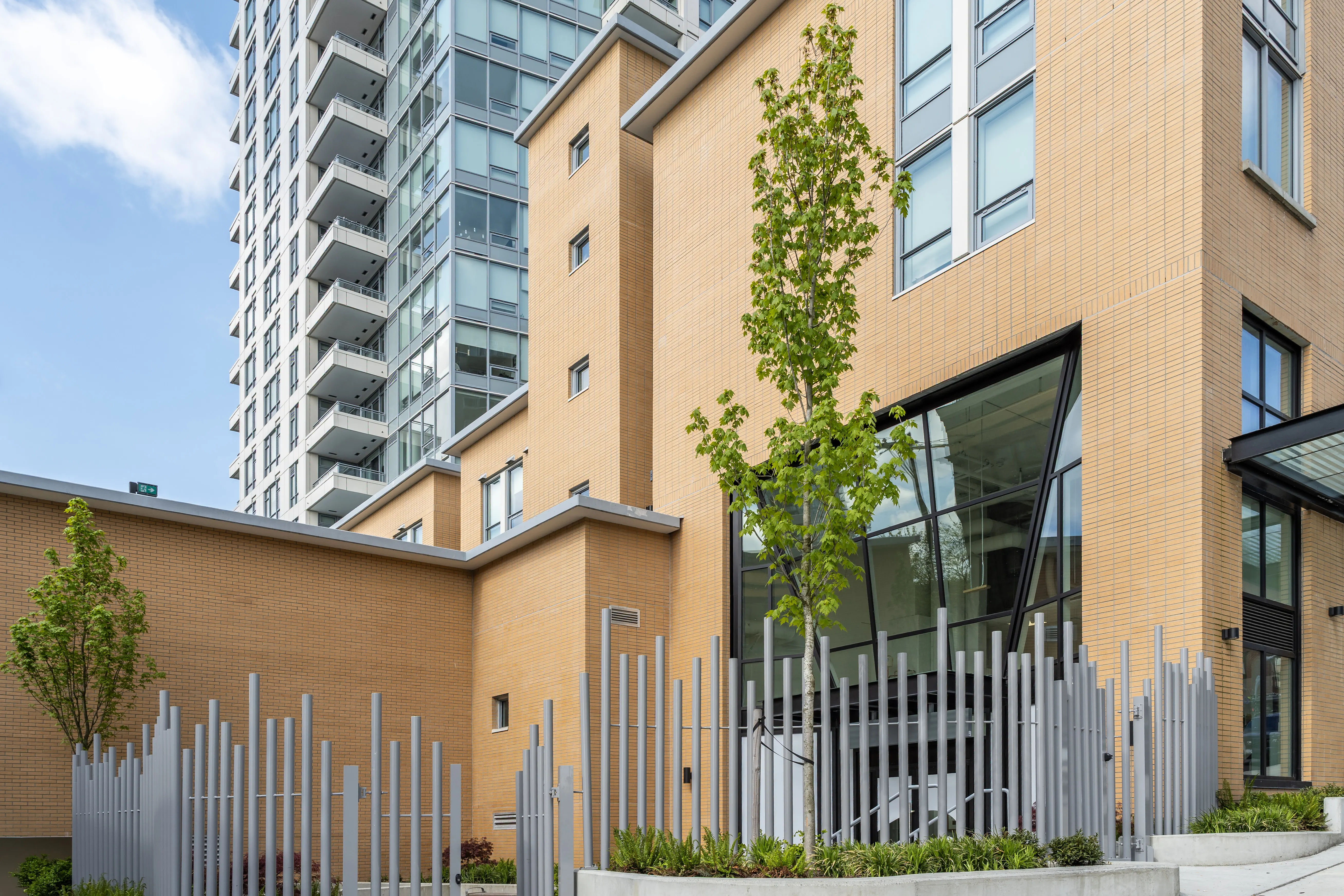 Vertical posts and planting at the base of a residential tower at 618 Carnarvon