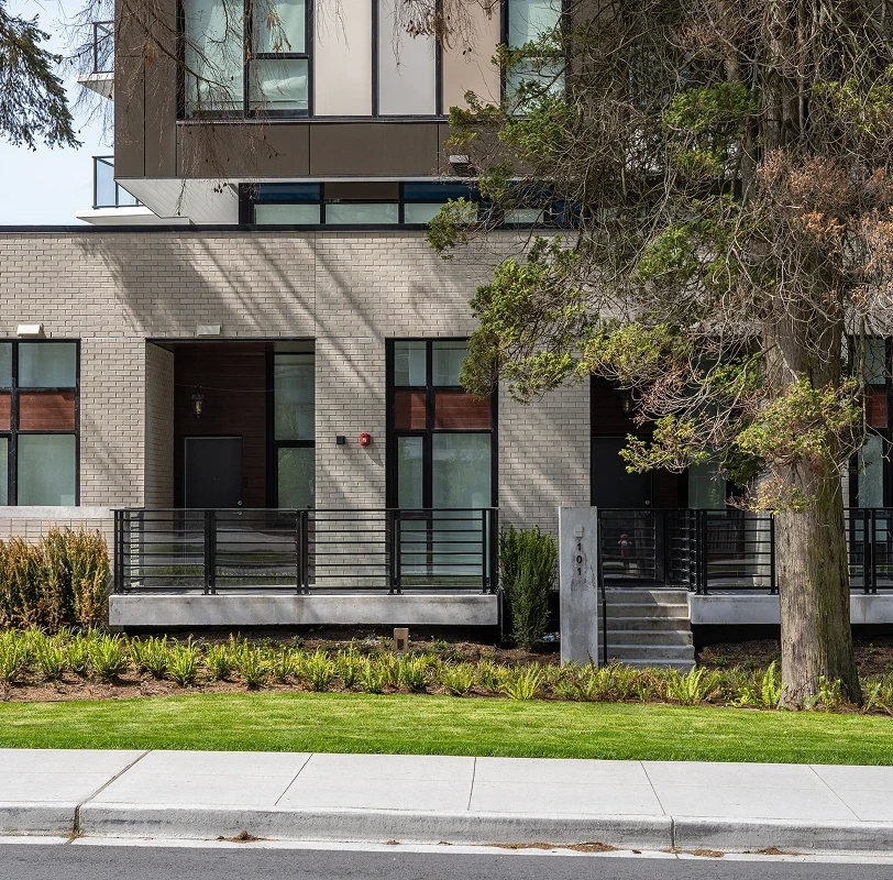 Hedges and lawn in front of townhomes at Melrose